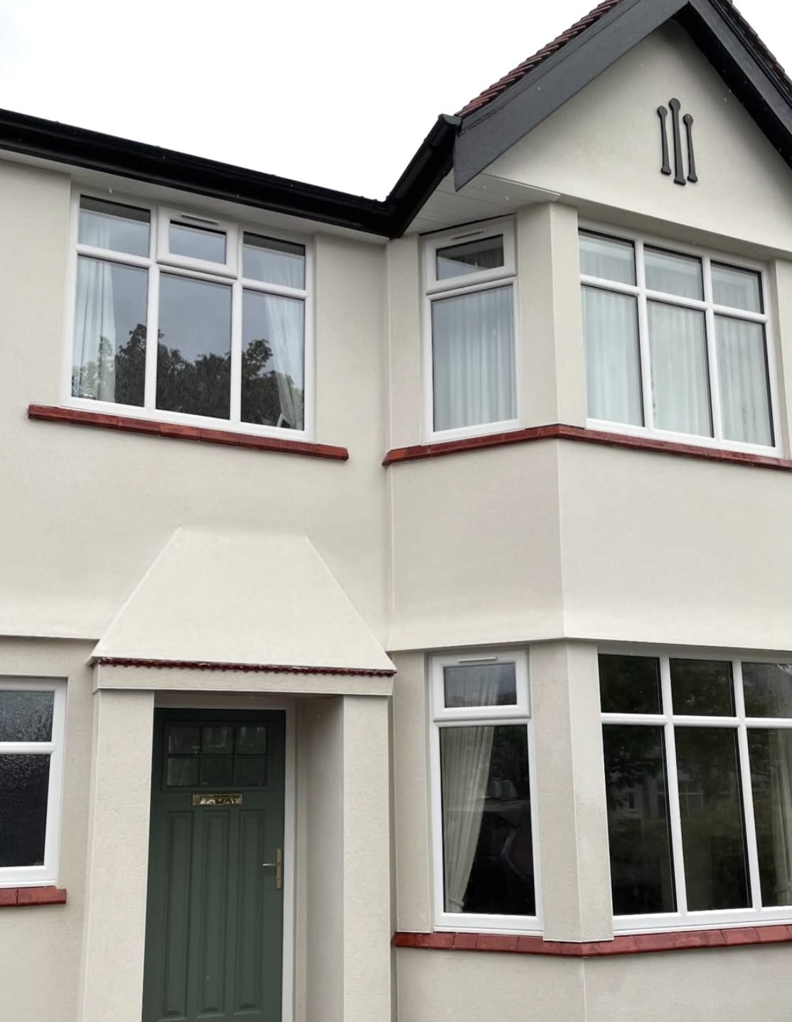1930s semi with curved bays in a cream finish and red tile sills